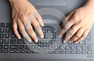 Human hands on keypads laptop keyboard working work from home typing business finance photo