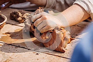 Human hands knead clay