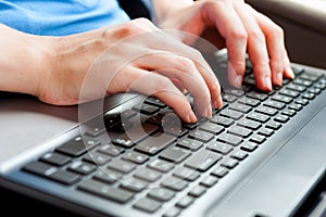 Human Hands on the laptop keyboard close up