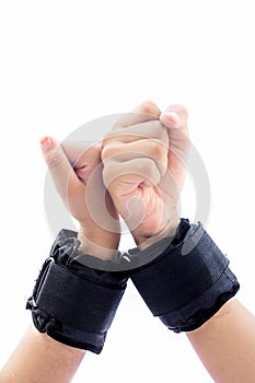 Human hands one of male and another one of female isolated on white wearing black colored wrist bands or wrist weights isolated on