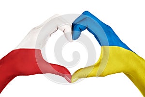 Human hands, painted with Poland and Ukraine flags,  forming heart shape