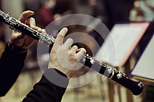 Human hands playing the oboe