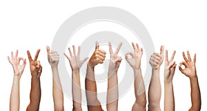 Human hands showing thumbs up, ok and peace signs