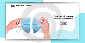 Human hands tearing medical mask apart covid-19 is over ending coronavirus pandemic quarantine concept