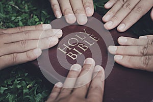 Human hands touch the Bible. Concept. Belief in God. Living according to God's word