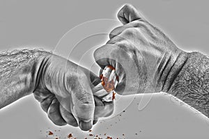 Human hands violently breaking cigarettes