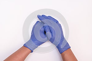 Human hands wearing blue surgical latex nitrile gloves for doctor and nurse protection during patient examination on white