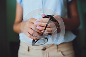 Human hands woman holding eyeglasses