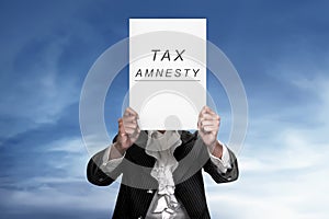 The human holding paper reads tax amnesty