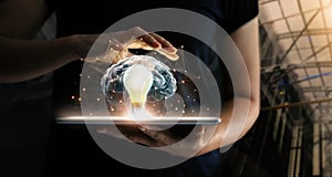 Human holding tablet with light bulb future technology photo
