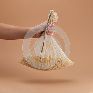 Human holds in hand a reusable fabric eco bag with pasta. Reusable eco-friendly products. Zero waste and sustainable