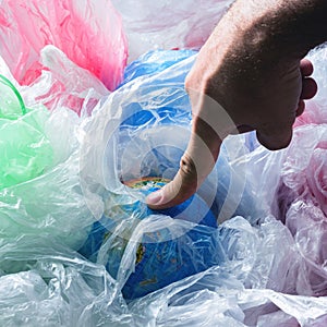 Human Impact Environment Pollution concept Earth plastics bags