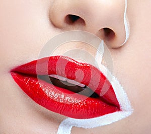 Human mouth and nose. Closeup macro portrait of female part of face with painting