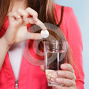 Human with painkiller pill and water. Health care.