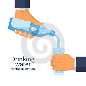 Human is picking up a glass of water from a plastic bottle