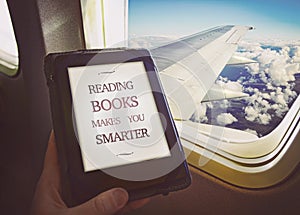 Human reading book inside airplane