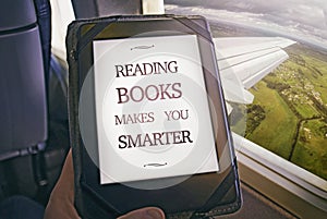 Human reading book inside airplane