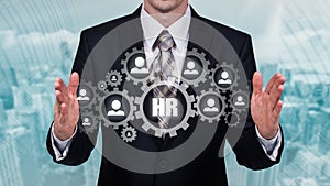 Human resource business concept. Businessman presses hr icon on virtual screen