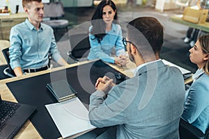 Human resource team talking to a candidate during a job interview in modern office