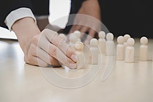 Human Resources. business people choosing wooden leader man from crowd of employee on desk, team leader, human resources manager,