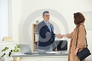 Human resources manager shaking hands with applicant after job interview