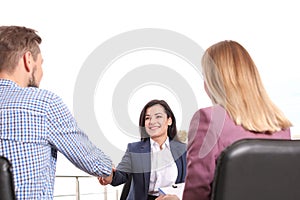 Human resources manager shaking hands with applicant during job interview