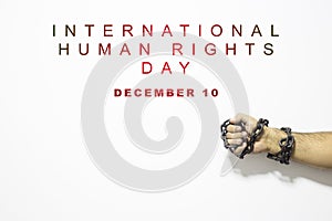 Human rights concept: chained man against the text: Human rights day written on white.