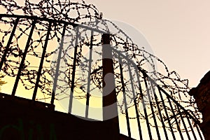 human rights concept - iron gate with barbed wire - isolation, quarantine, epidemic, pandemic, virus