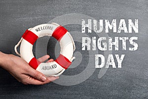 Human Rights Day. Welcome aboard sign. Black chalk board background