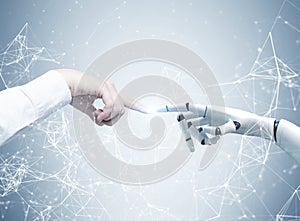 Human and robot hands reaching out, network photo