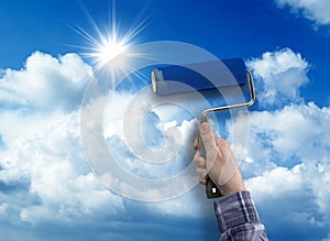 Human with roller paint sky