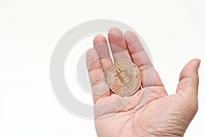 Human`s hand holding cryptocurrency golden bitcoin on white isolated background. Virtual digital money concept.