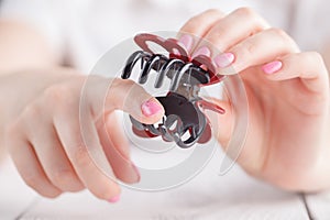 Human`s hand holding hairclip opened