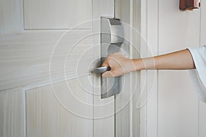 Human`s hand holding modern door handle  for checking lock system , opening or closing door