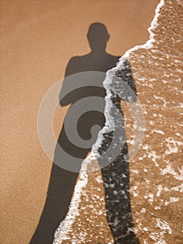 Human shadow on the sand