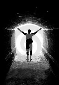 Human silhouette in tunnel exit