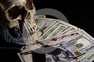 Human skull on the background of the American flag, dollars and military medallions. Concept: military special operations