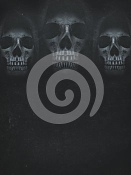 Human skull in hood on dark background. Halloween banner