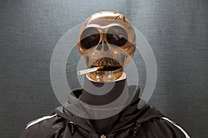 Human skull smoking a cigarette on a black background, Cigarette very dangerous for people. Please don't smoke.Halloween day