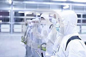 Human in sterile suits disinfectant spray coronavirus  big cleaning