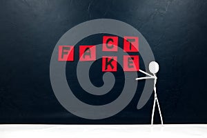 Human stick figure changing word fact to fake. Facts versus false news concept.