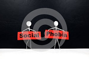 Human stick figure holding red Social Phobia word banner. Black background.
