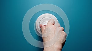 Human Switches On A Toggle Switch On The Blue Wall
