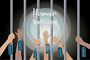 Human Trafficking and human rights concept. Abused hands with sale label tag imprisonment in jail bars asking hopeless for help