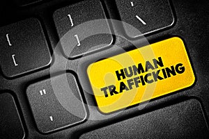 Human Trafficking is the trade of humans for the purpose of forced labour, text button on keyboard, concept background