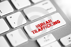 Human Trafficking is the trade of humans for the purpose of forced labour, text concept button on keyboard