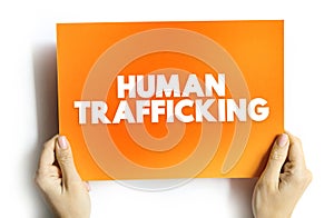 Human Trafficking is the trade of humans for the purpose of forced labour, text concept on card for presentations and reports