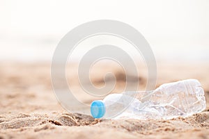 Human waste throw away junk water bottle on the sand