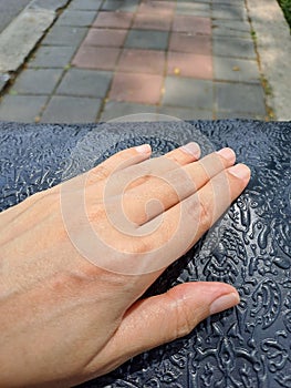 Human woman hand beauty holding a blue batik bag