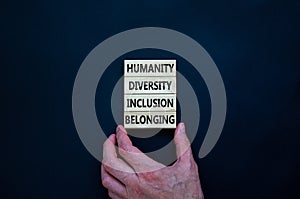 Humanity, diversity, inclusion, belonging symbol. Wooden blocks with words humanity, diversity, inclusion, belonging on beautiful